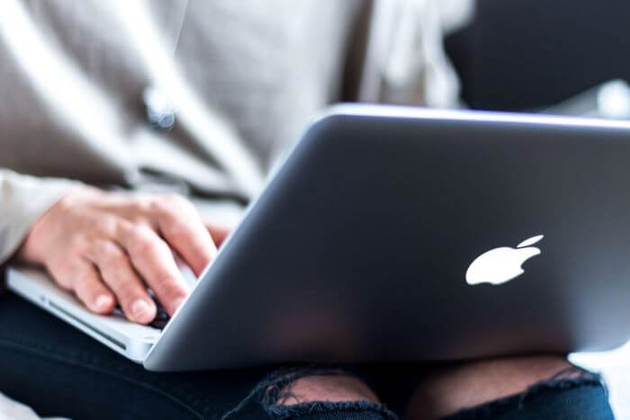 Person working on an Apple MacBook laptop